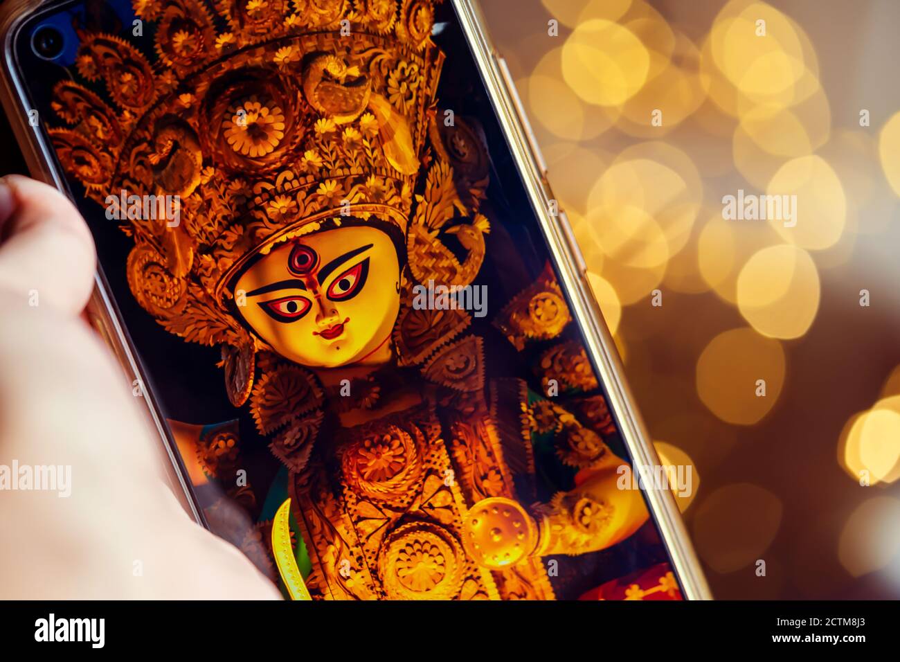 Happy Durga Puja background Image with copy space. Female hand scrolling or  viewing Durga Puja photos on her smartphone. Indian biggest Hindu festival  Stock Photo - Alamy