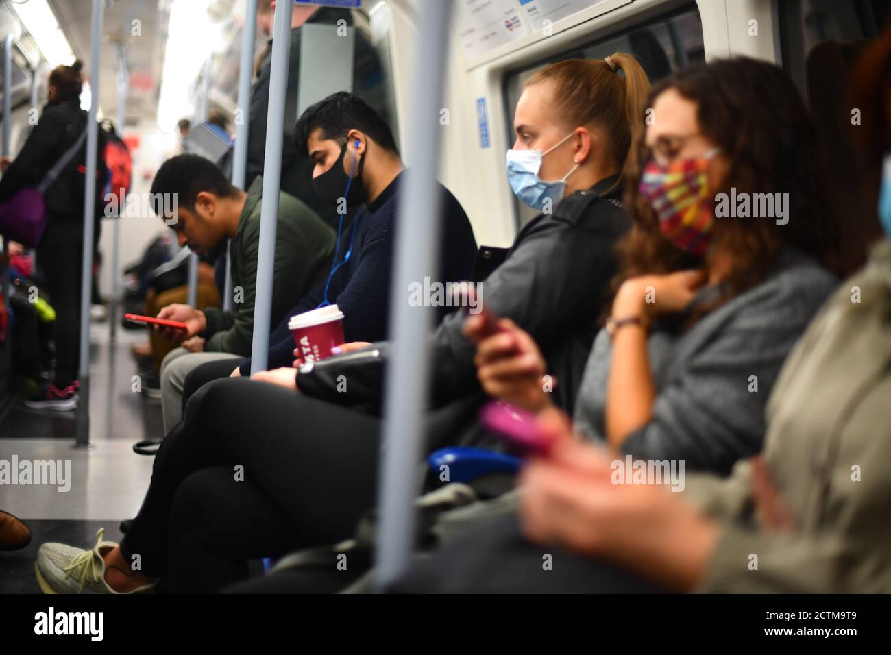 Commuters on a Jubilee line London Underground train, at 08:15hrs, as they head to central London, after Prime Minister Boris Johnson announced a range of new restrictions to combat the rise in coronavirus cases in England. Stock Photo