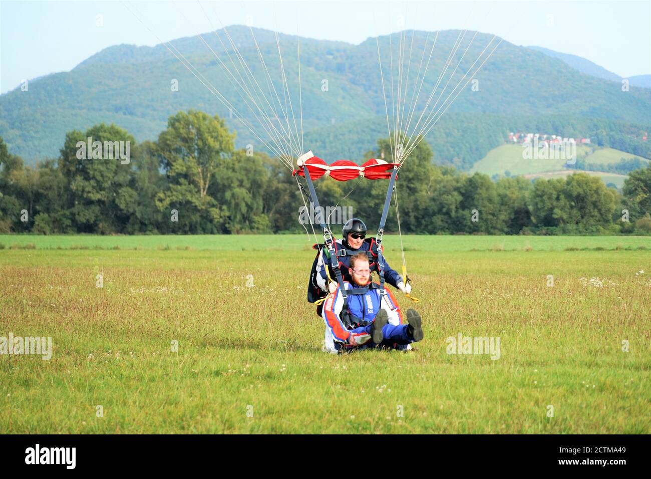 Tandem parachute jump shortly before landing in Slovakia at the Slavnica Aeroklub on Sept.20, 21020. Stock Photo