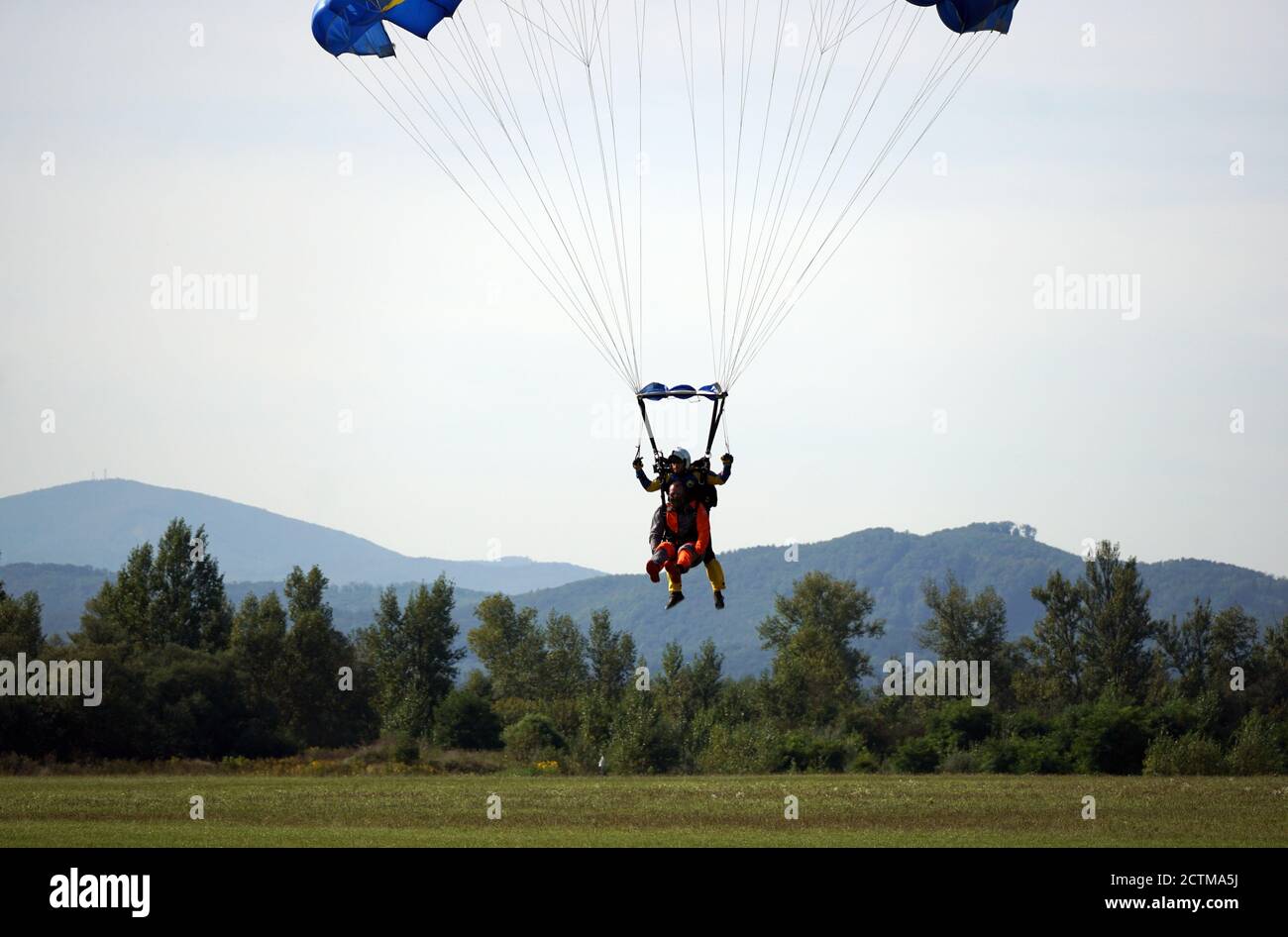 Tandem parachute jump shortly before landing in Slovakia at the Slavnica Aeroklub on Sept.20, 21020. Stock Photo