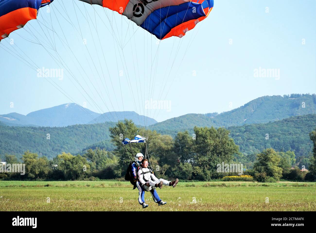 Tandem parachute jump shortly before landing in Slovakia at the Slavnica Aeroklub on Sept.20, 21020. Stock Photo