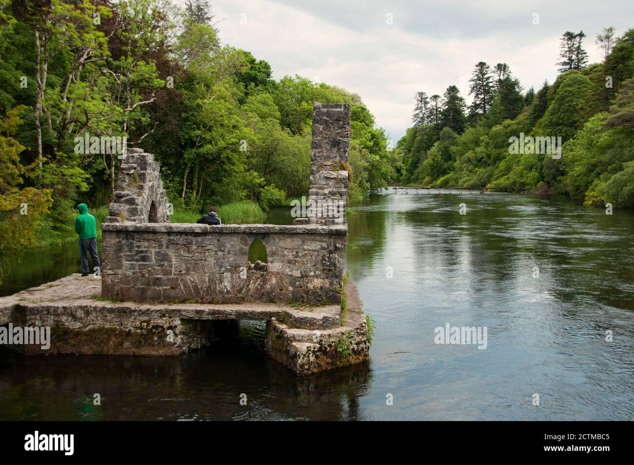 Two teenagers fishing on the Monk Fish House located in Cong, Ireland