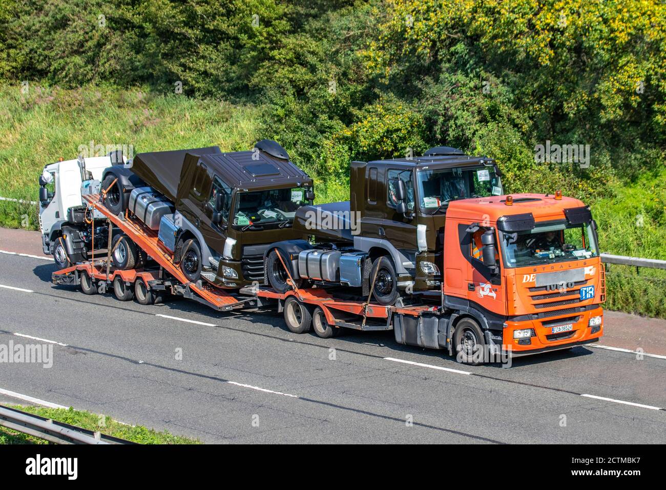 De Rooy Leyland Haulage delivery trucks, lorry, transportation, lowloader truck, cargo carrier, new DAF vehicle, European commercial transport, industry, M6 at Manchester, UK Stock Photo