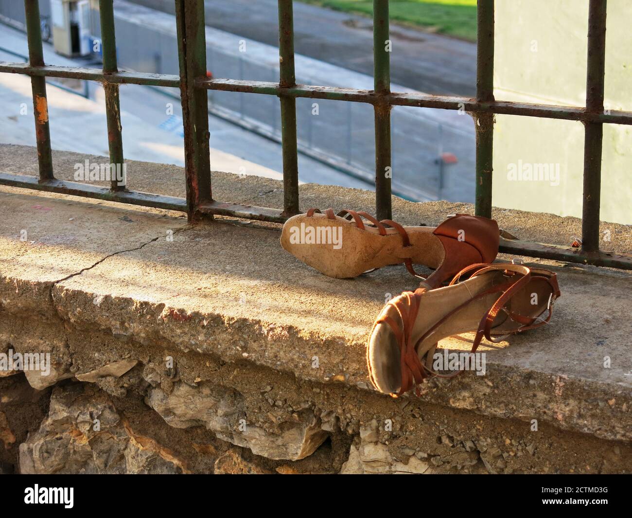 Worn woman's leather shoes left on a ledge for someone who would be in need  to take. Concept : Minimalism in Photography, reusing items Stock Photo -  Alamy