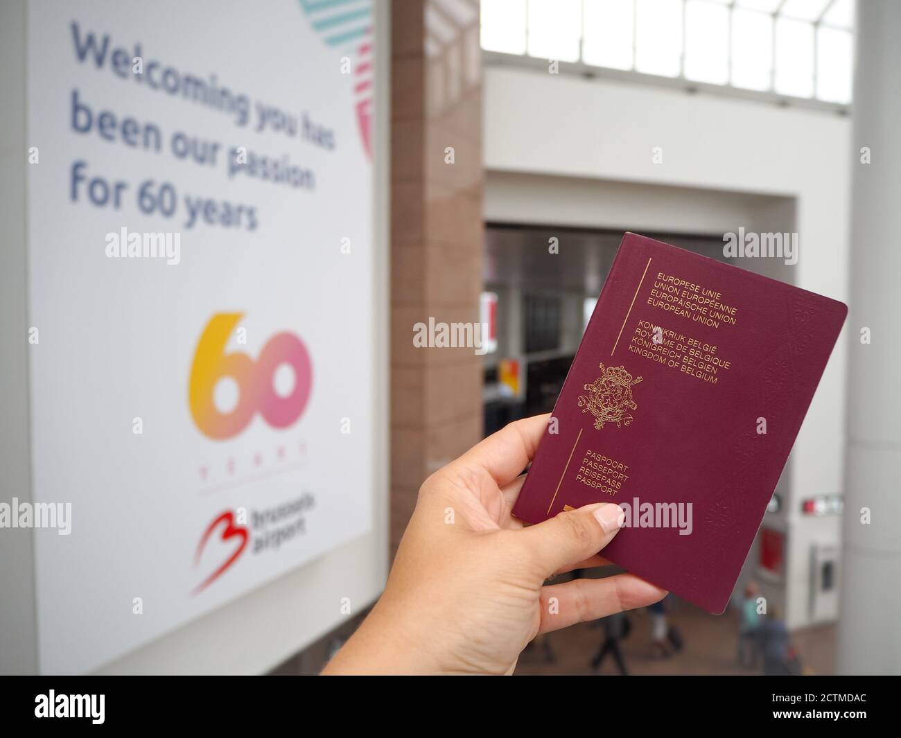 August 2018 - Zaventem,Belgium:Hand holding a Belgian passport at the check-in hall of the Brussels airport that just celebrated the 60th anniversary. Stock Photo