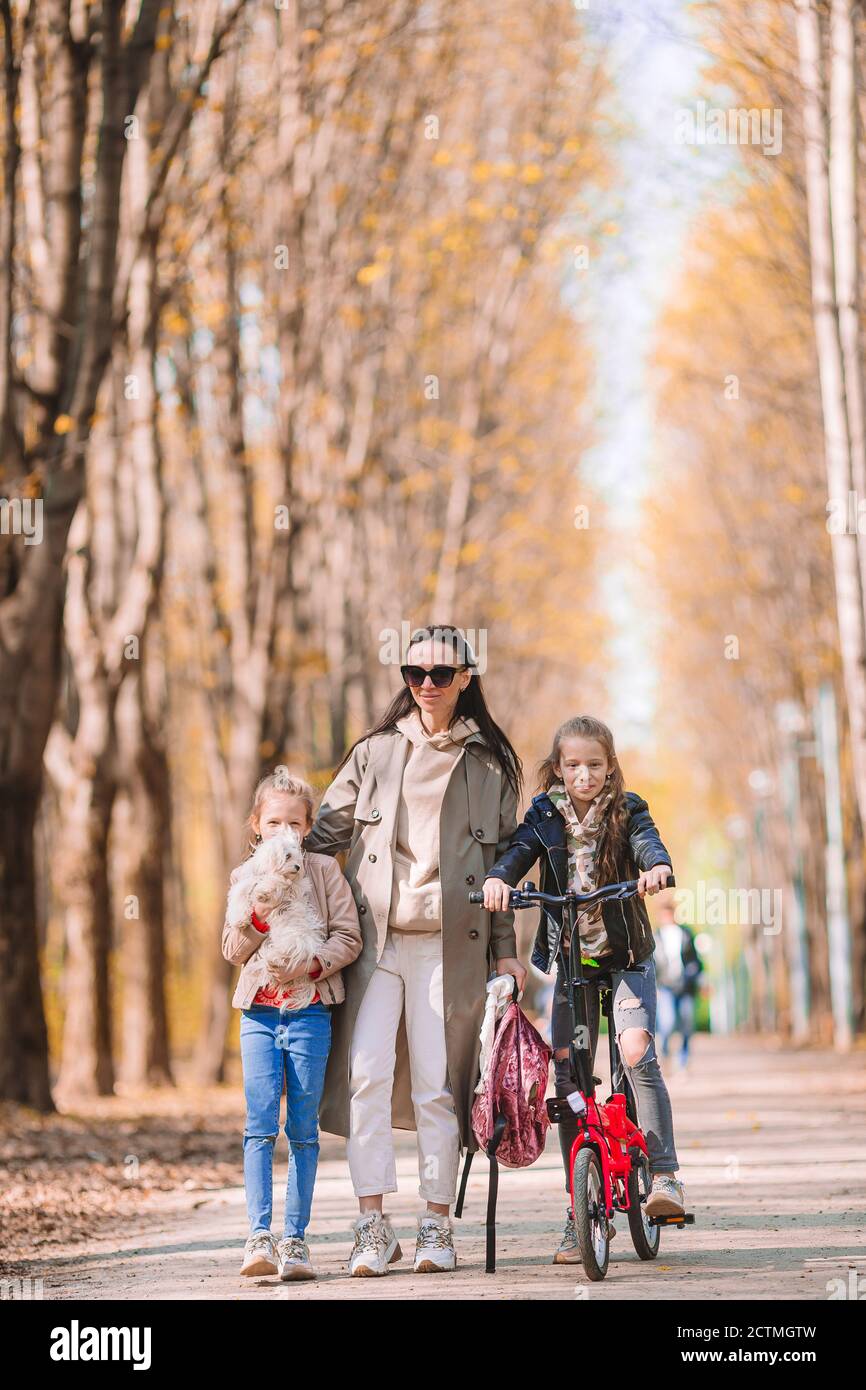 Little girls with mom outdoors in park at autumn day Stock Photo - Alamy