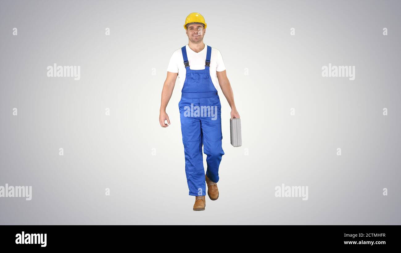 Carpenter walking on gradient background. Stock Photo