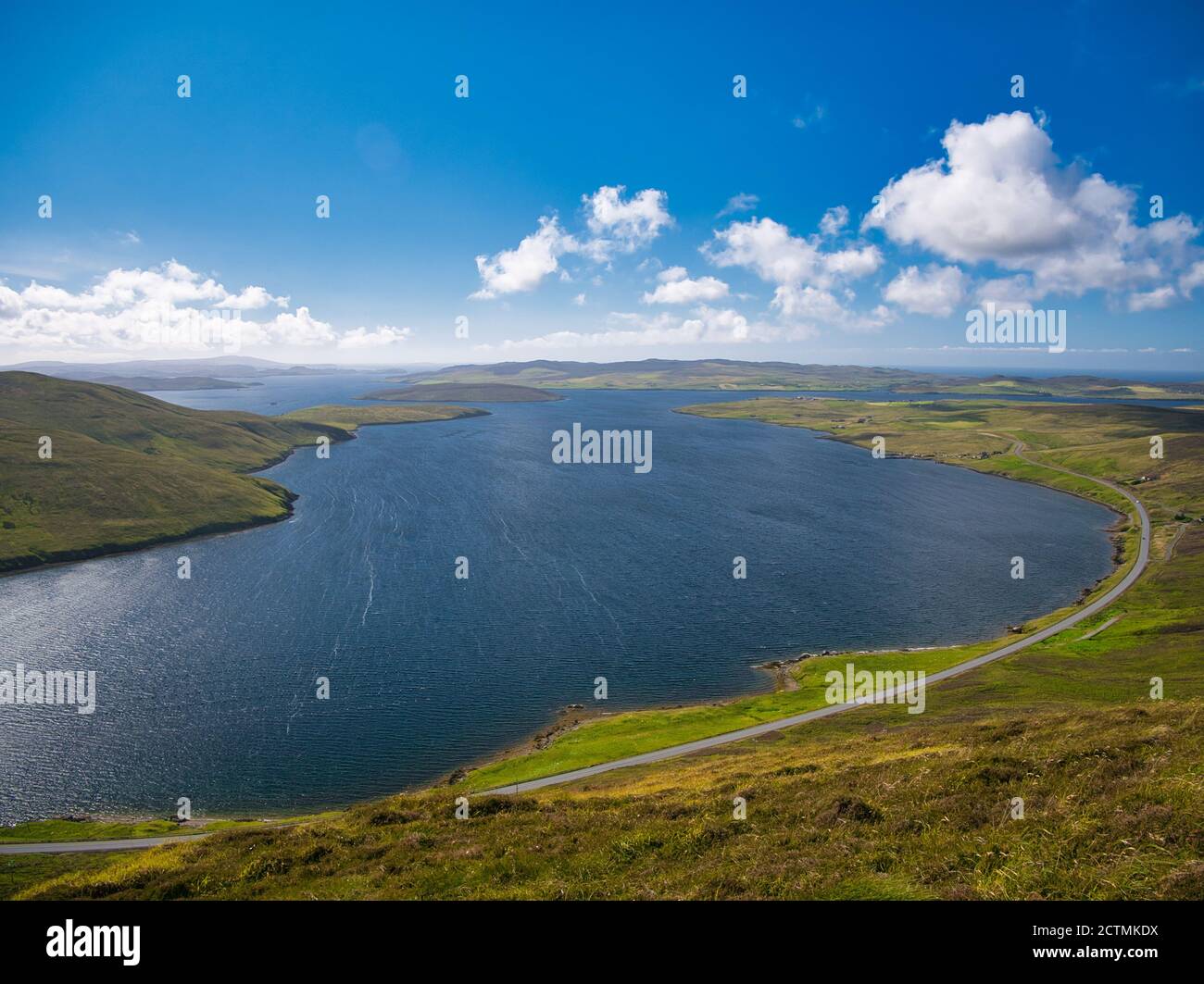 Taken on a sunny summer day, a view across the water of Olna Firth from the hillside of the Clubb of Mulla near Voe in Mainland, Shetland, UK. The isl Stock Photo