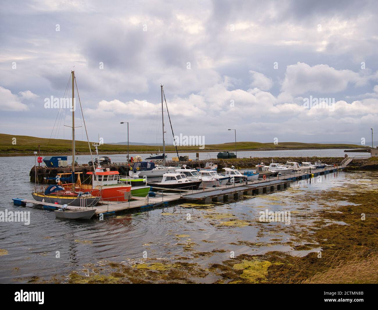 Fishing and leisure boats moored at Burravoe Marina on the south east of the island of Yell in Shetland, UK Stock Photo