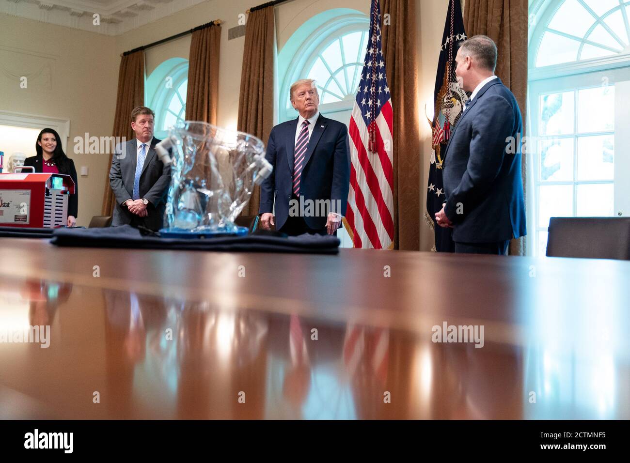 President Trump at a Briefing with NASA. President Donald  J. Trump listens during a briefing with NASA Administrator Jim Bridenstine and Dave Gallagher, Associate Director at the NASA Jet Propulsion Laboratory, discussing NASA’s response to the COIVD-19 Coronavirus Friday, April 24, 2020, in the Cabinet Room of the White House. Stock Photo