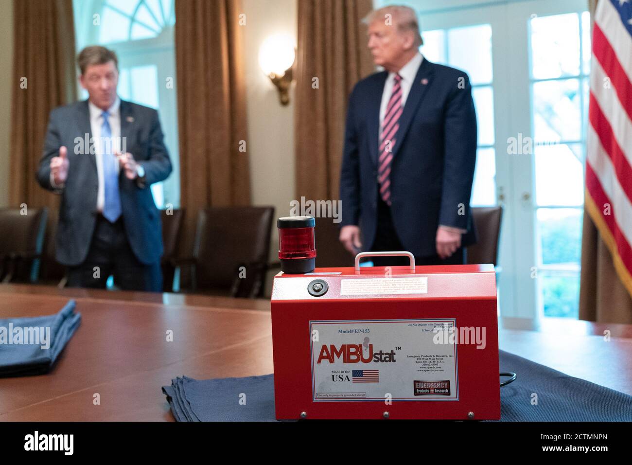 President Trump at a Briefing with NASA. President Donald  J. Trump listens during a briefing with Dave Gallagher, Associate Director at the NASA Jet Propulsion Laboratory, explaining the development of devices like the AMBUstat  that helps decontaminate spaces like ambulances in less than hour, as part of NASA’s response to the COIVD-19 Coronavirus Friday, April 24, 2020, in the Cabinet Room of the White House. This device was developed from technology used to sterilize a spacecraft. Stock Photo