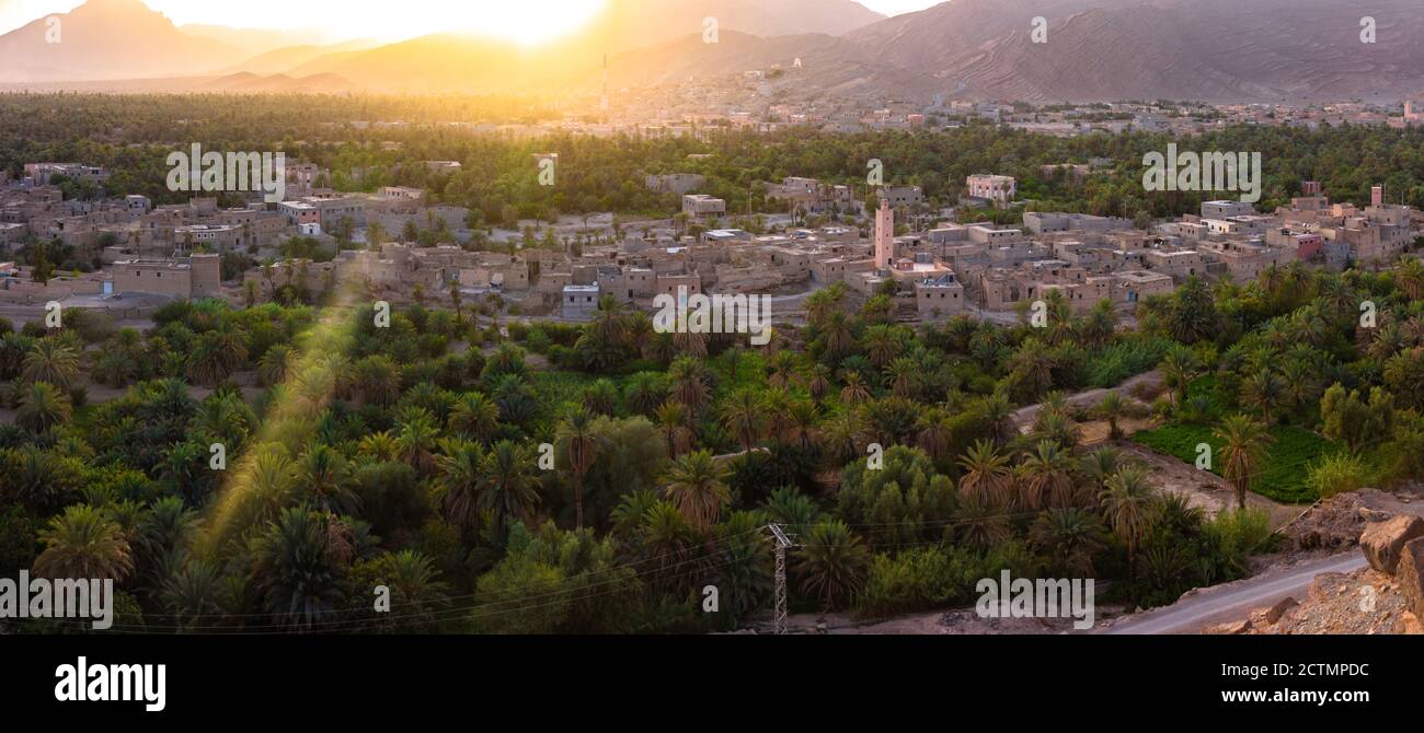 Panoramic view of Moroccan berber palm oasis and old buildings, beautiful landscape of Tighremt village and gorgeous sunset in Anti Atlas Stock Photo