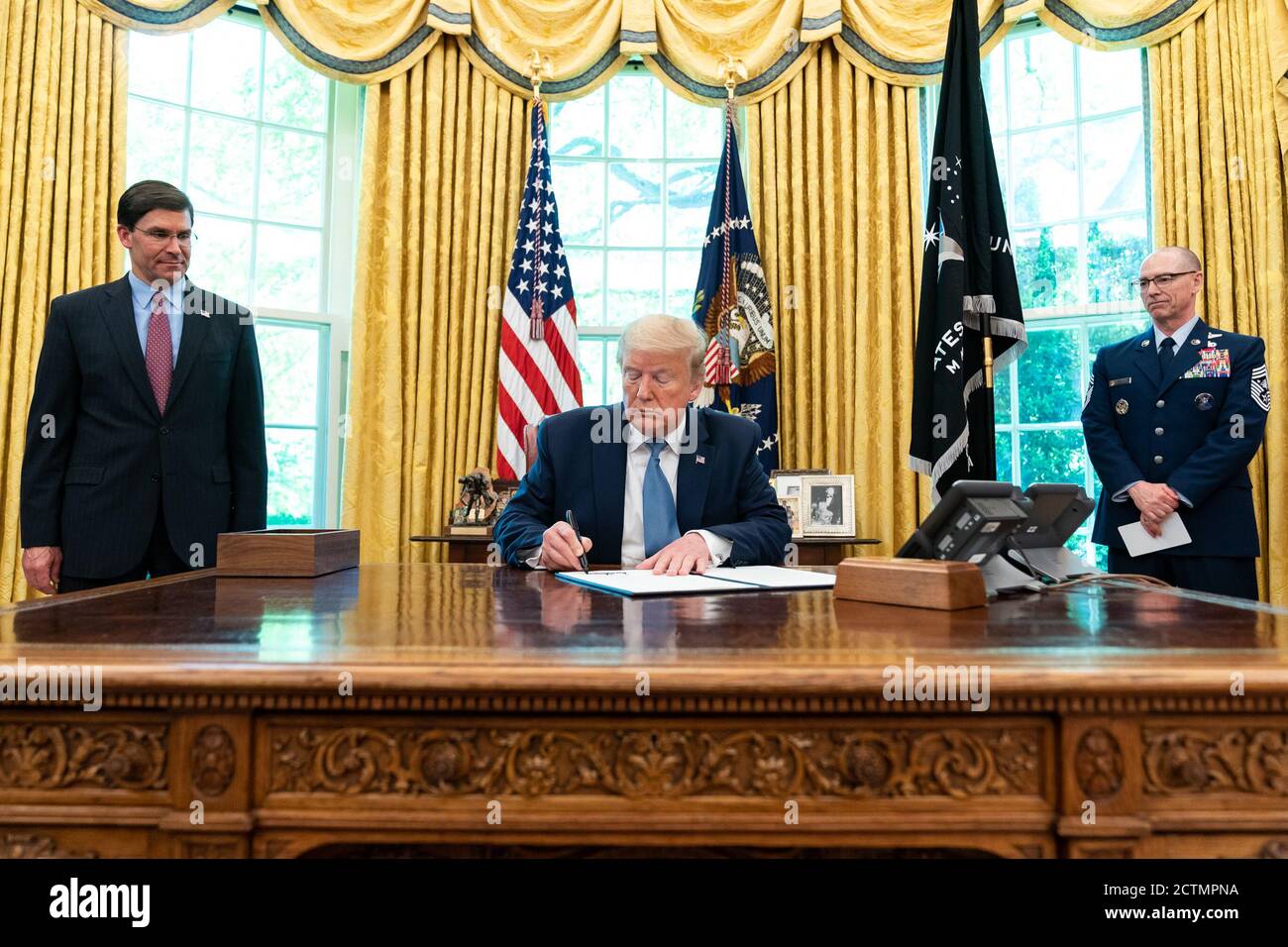 President Trump Signs an Armed Forces Day Proclamation. President Donald J. Trump, joined by Department of Defense Secretary Mark Esper and US Space Force Senior Enlisted Advisor CMSgt Roger Towberman, signs an Armed Forces Day Proclamation Thursday, May 15, 2020, in the Oval Office of the White House. Stock Photo