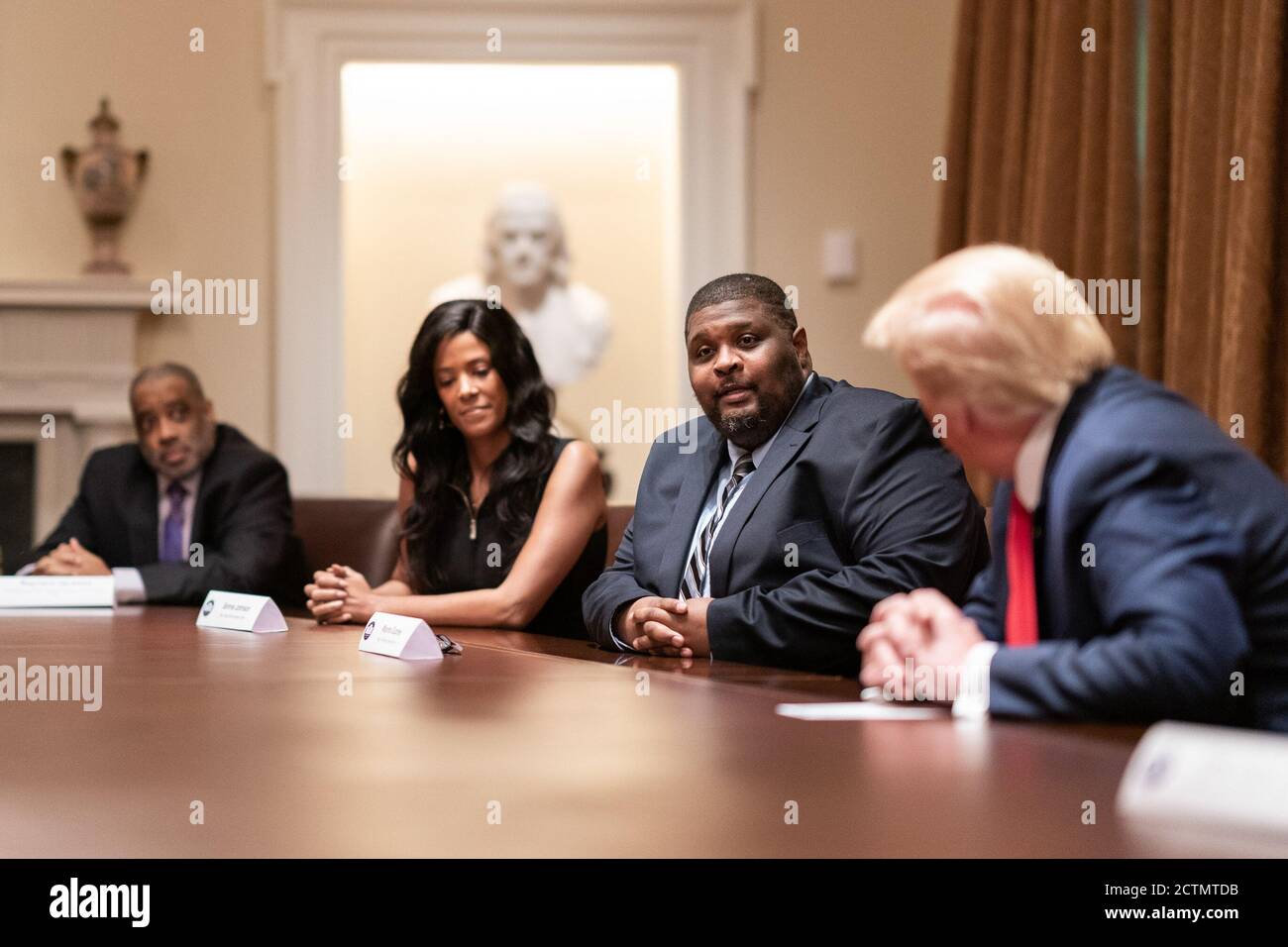President Trump Participates in a Roundtable on Race Relations. President Donald J. Trump listens radio host Wayne Dupree address her remarks during a roundtable on race relations Wednesday, June 10, 2020, with prominent black leaders in the Cabinet Room of the White House. Stock Photo