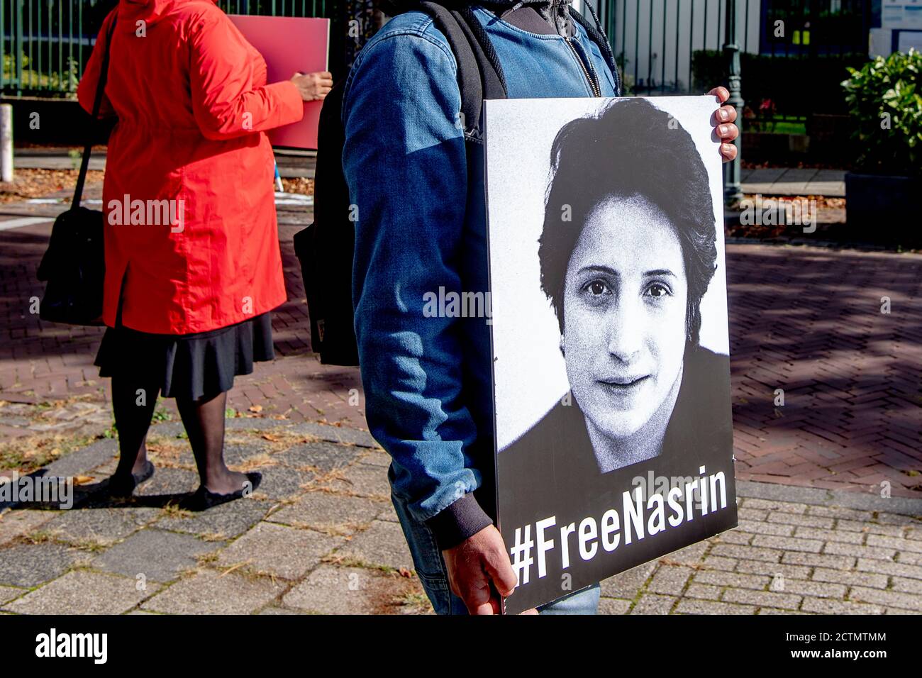 The Hague, Netherlands. 24th Sep, 2020. A man stands holding up a placard  with a picture of Nasrin with a message below reading #FreeNasrin in The  Hague.Amnesty International calls on the Iranian