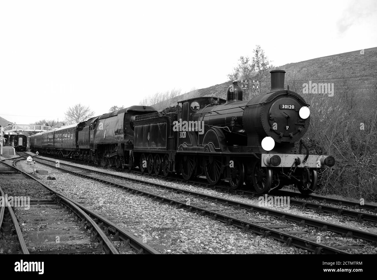 '30120' and 'Manston' double heading through Corfe Castle Station. Stock Photo
