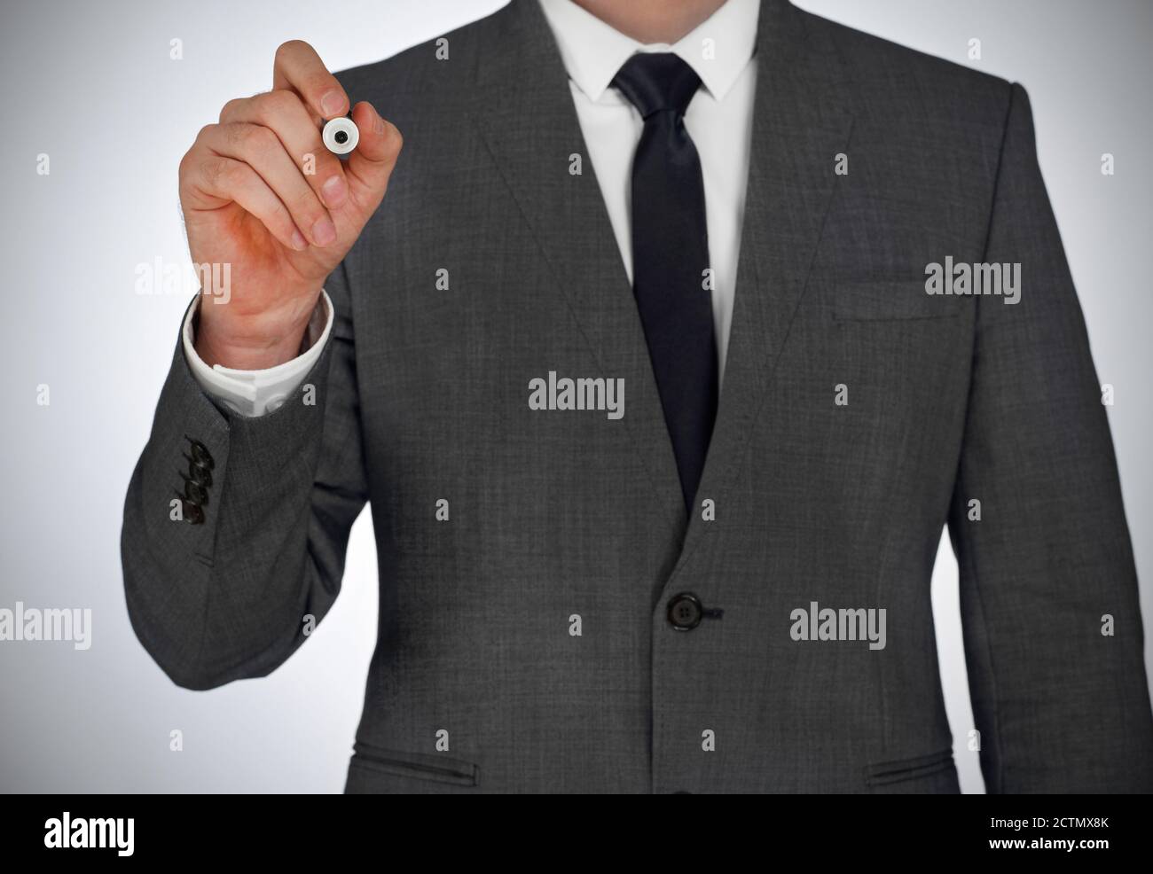 Businessman writing on a virtual screen Stock Photo