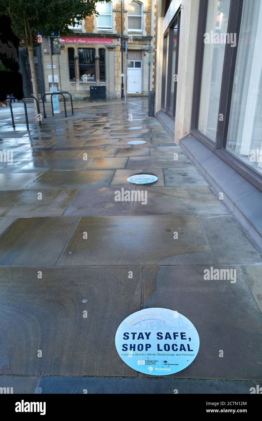 'Stay safe, shop local' notice on the pavement outside a shop at Kettering, Northants, England. Stock Photo