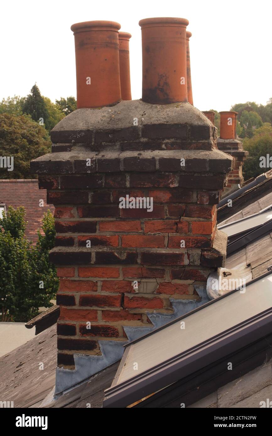 A view level with a traditional brick, four chimney pot stack house