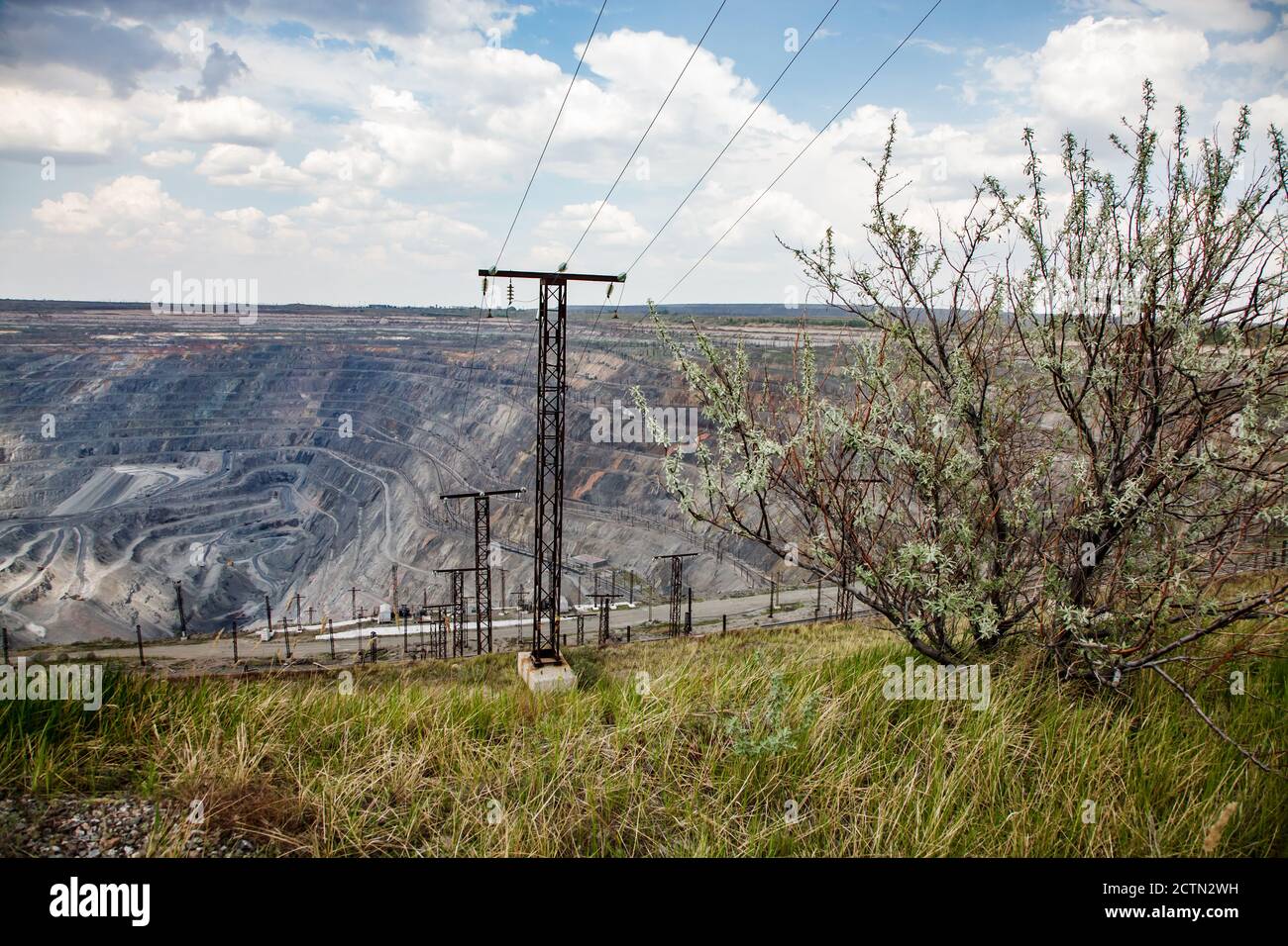 View on open pit mine. Giant iron ore quarry in Rudny, Kazakhstan. Mining raw minerals for steel production. Stock Photo