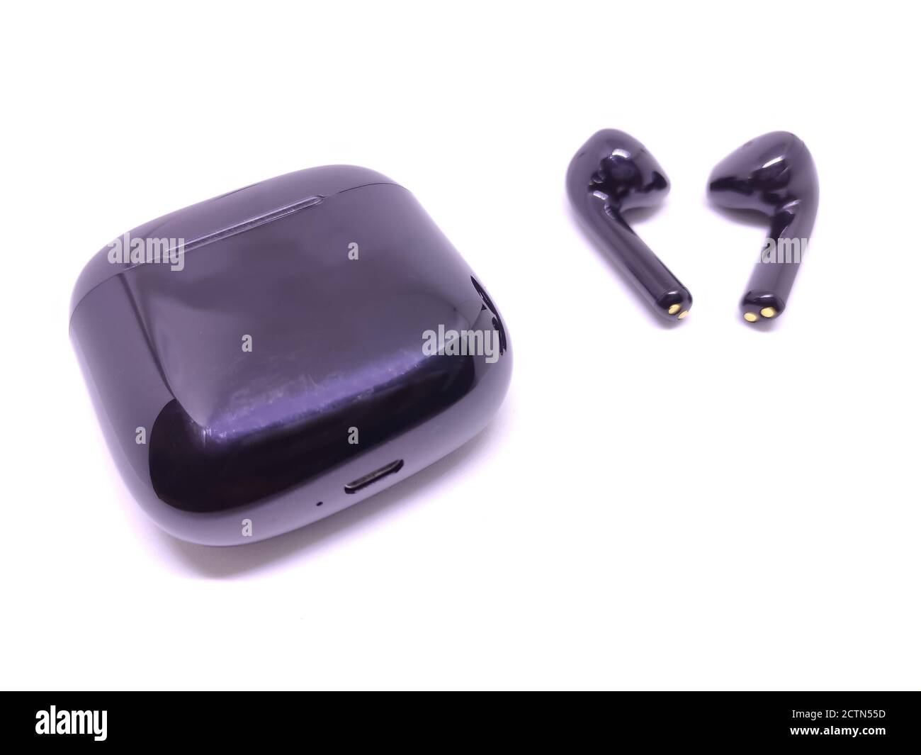 Black wireless headphone with case isolated on white background. Selective focus Stock Photo