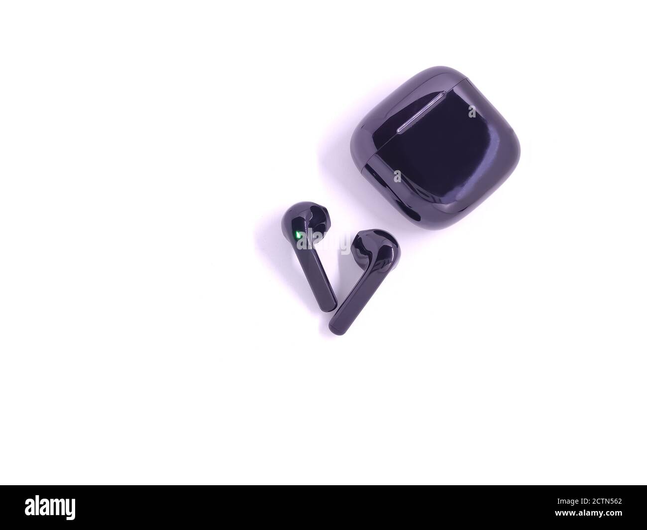 Black wireless headphone with case isolated on white background. Selective focus Stock Photo