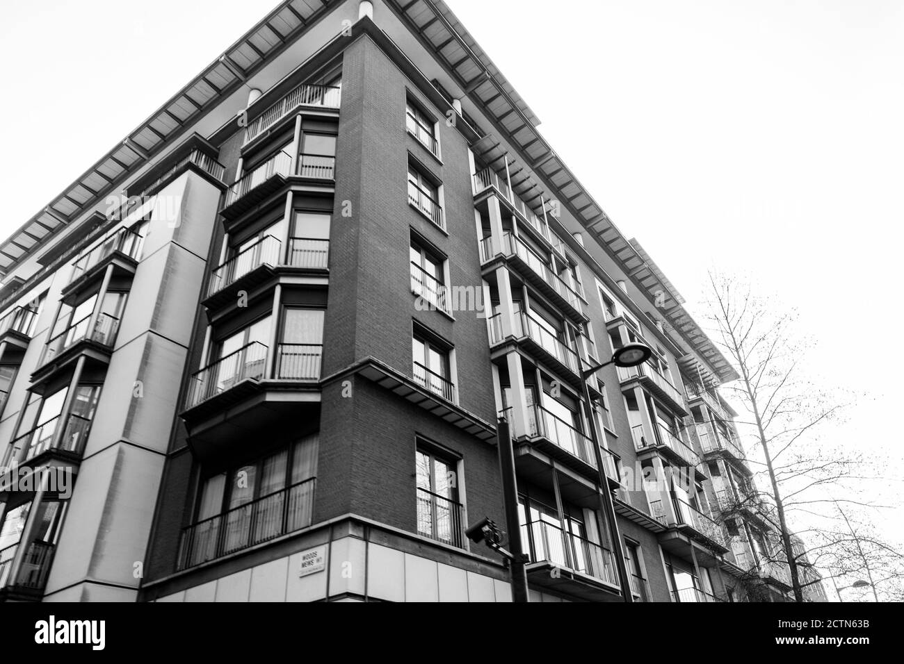 Gray scale low angle shot of a neat apartment building with balconies in winter Stock Photo