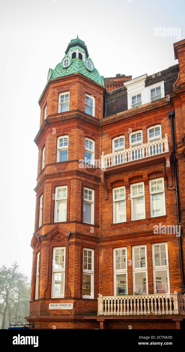 Vertical shot of a beautiful building made of brinks with white tall ...