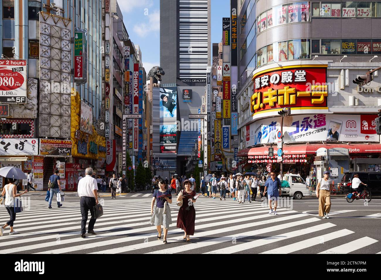 Zebra crossing and view from Yasukuni Dori toward Shinjuku Toho Building; Shinjuku, Tokyo, Japan Stock Photo