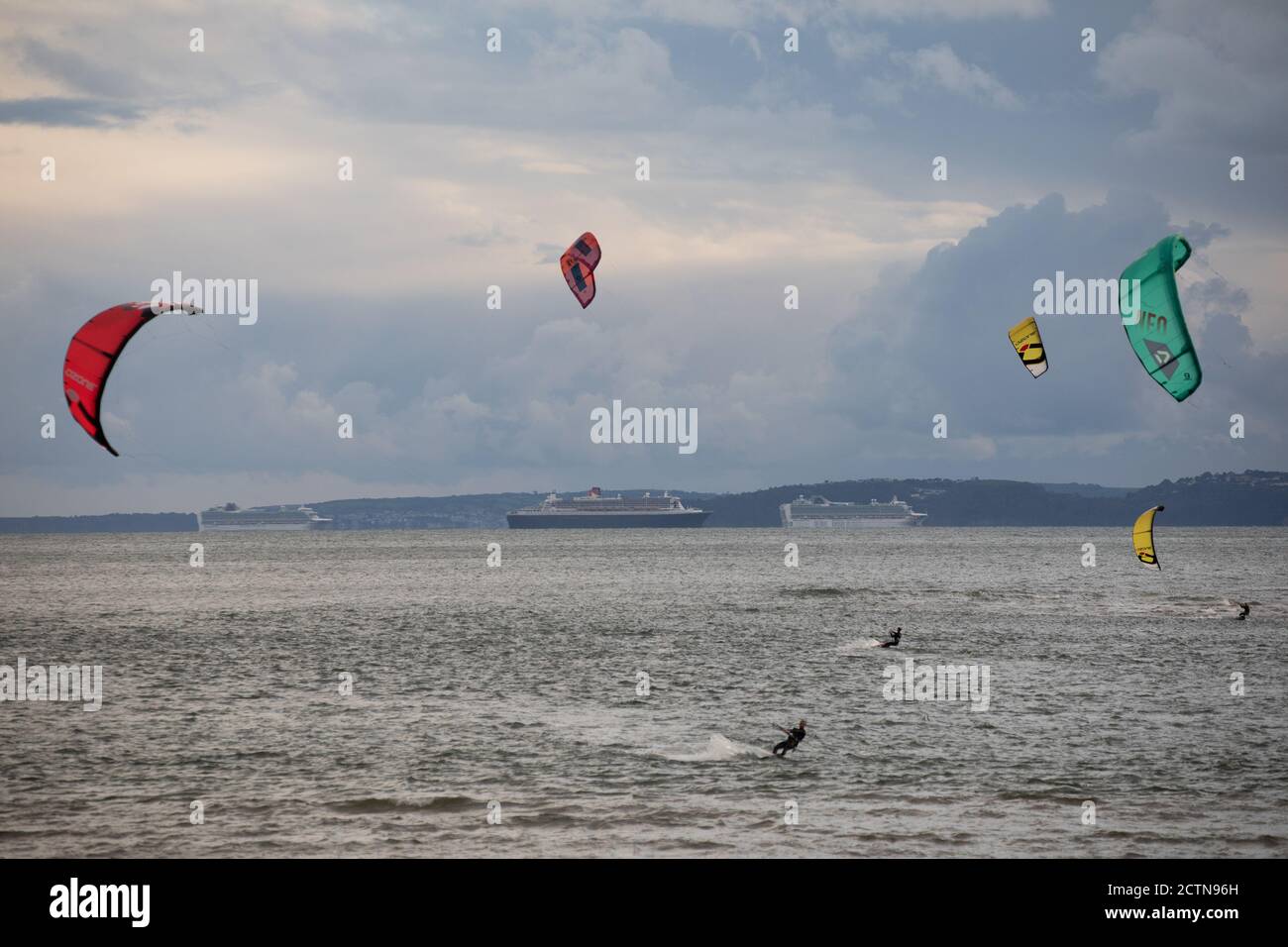 Kite surfers and watersports enthusiasts make the most of the windy conditions in Exmouth last night as windier weather is forecast for much of Englan Stock Photo