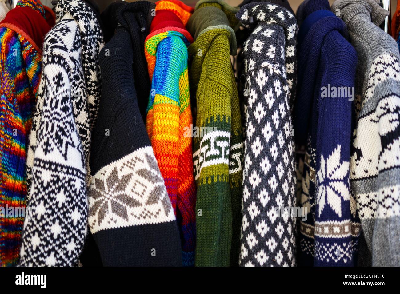 Closeup shot of colorful winter clothes hanging on the rack Stock Photo