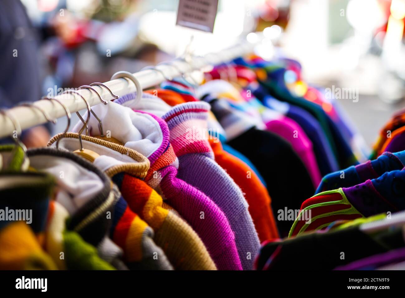 Closeup shot of colorful winter clothes hanging on the rack Stock Photo