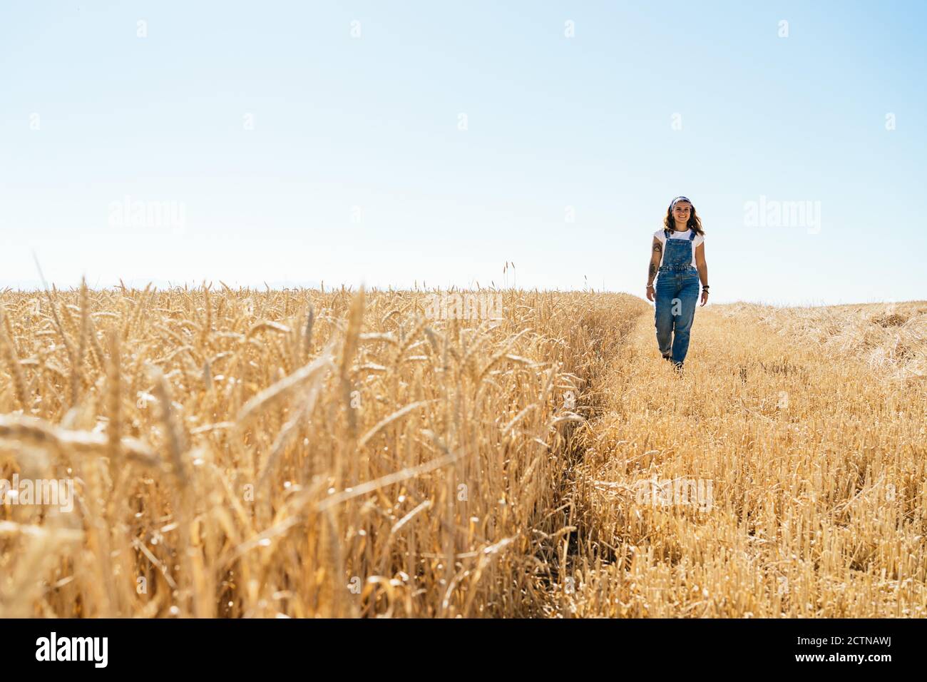 Woman in overalls walking field hi-res stock photography and images - Alamy