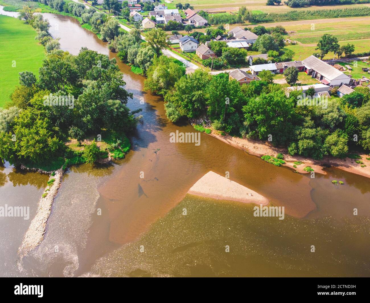 Junction of the rivers. Tributary of of large river surrounded by tress. Drone, aerial view Stock Photo