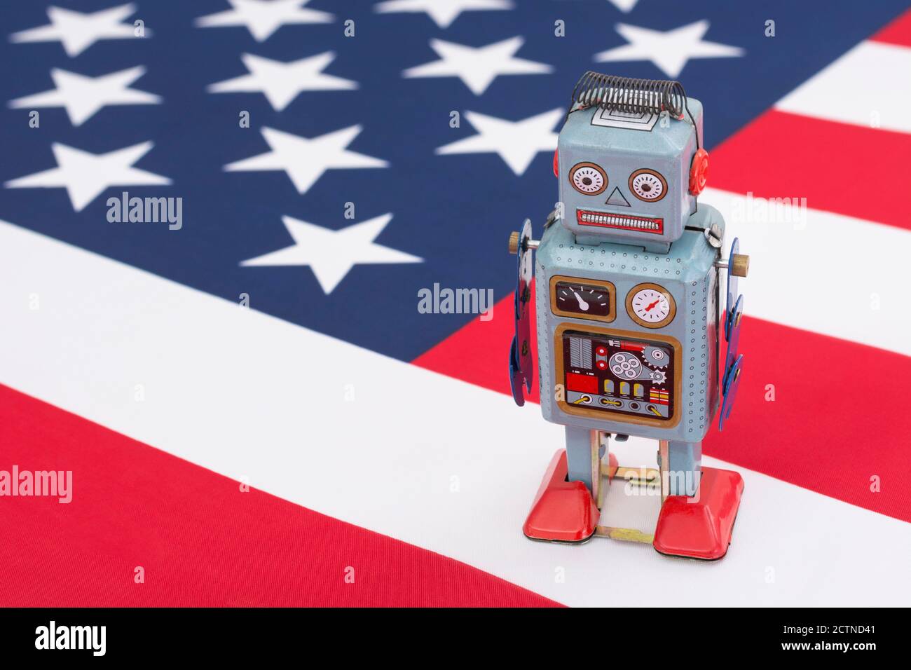 Clockwork toy robot on American flag / Stars & Stripes. For Russian Vulkan bots meddling in US election, Russian trolls bots, cyber threat to US Stock Photo