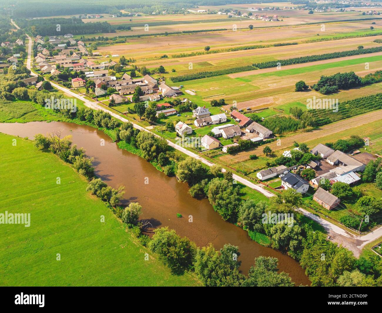 Small village over a small river. Drone, aerial view. Drone, aerial view Stock Photo