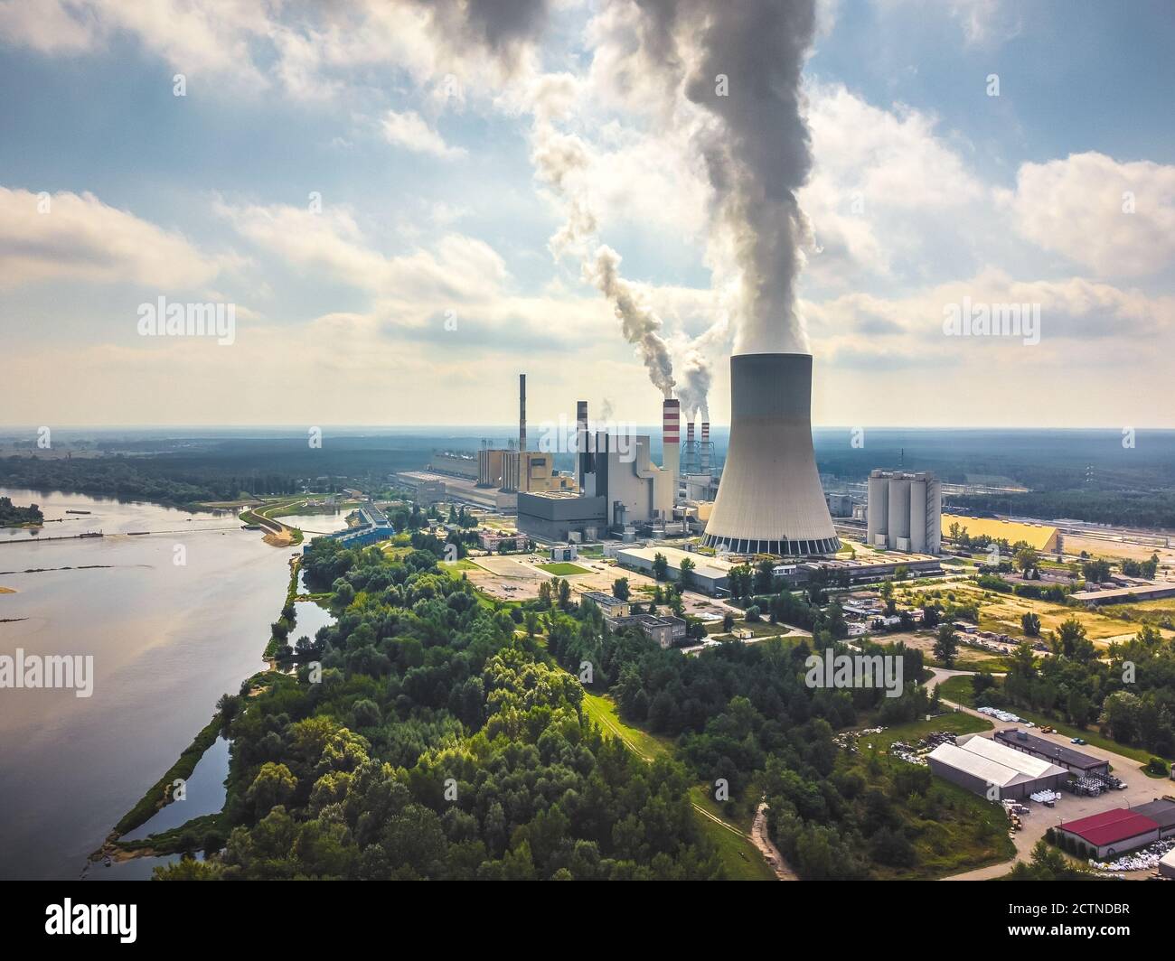 Large power station with steam coming from cooling tower. Drone, aerial view Stock Photo