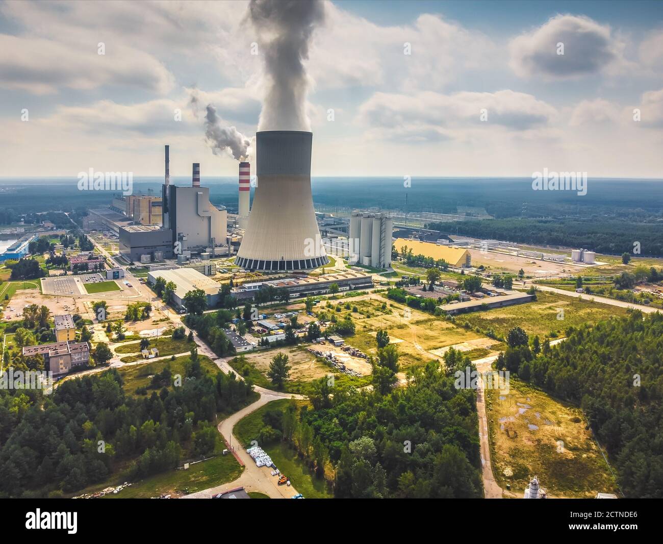 Large power station with steam coming from cooling tower. Drone, aerial view Stock Photo