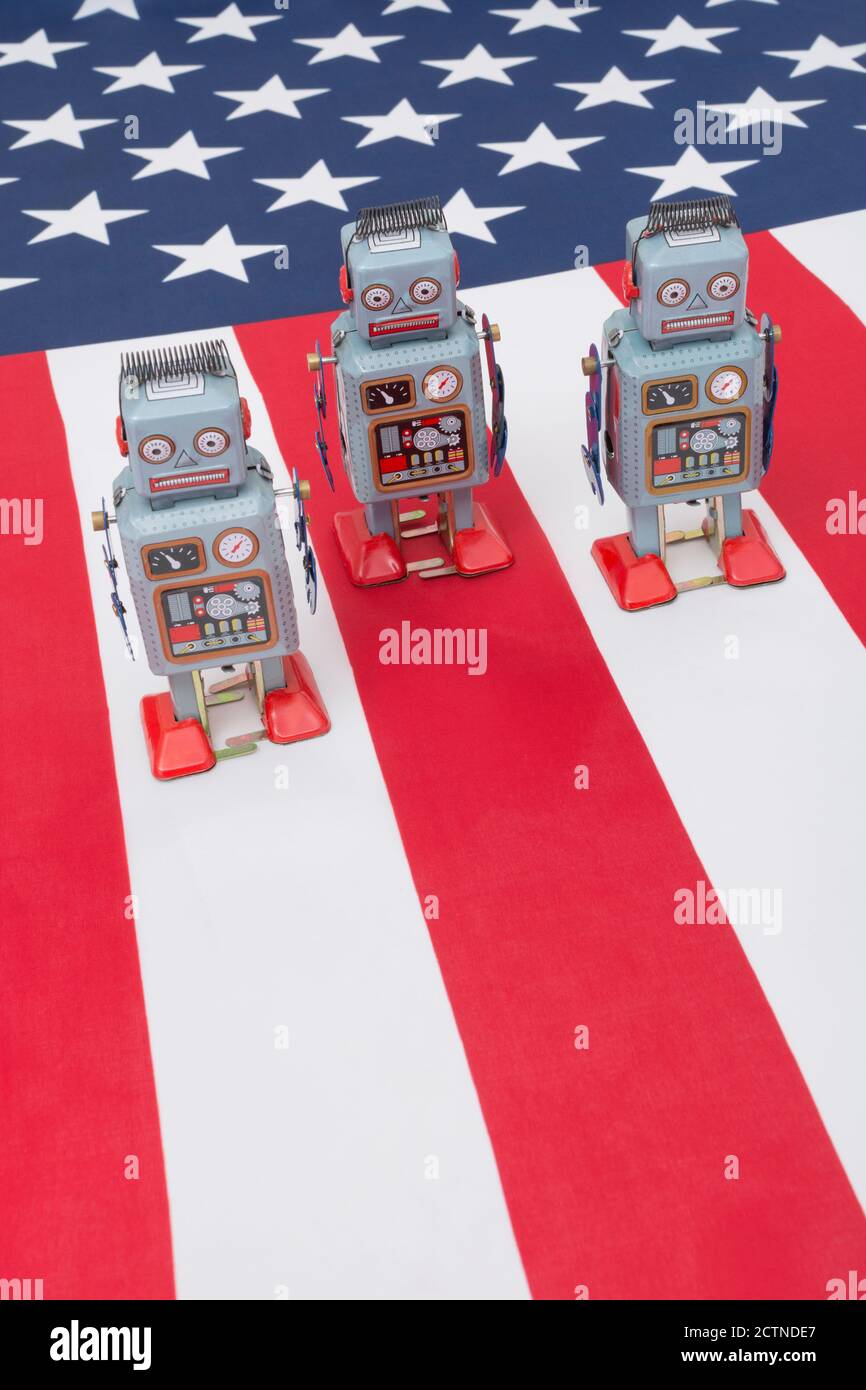 Clockwork toy robot on American flag / Stars & Stripes. For Russian Vulkan bots meddling in US election, Russian trolls bots, cyber threat to US Stock Photo