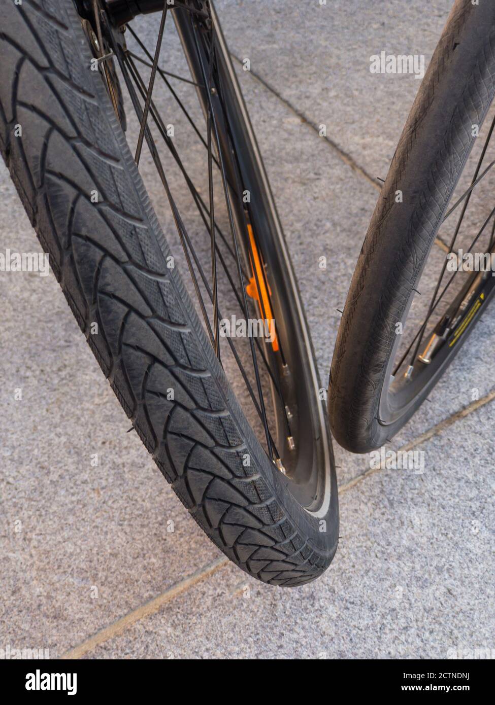 Top and close view of two bicycle wheels with different types of (tires