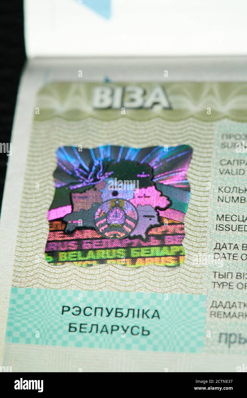 Illuminated visa stamp of Belarus  on passport page macro close up view Stock Photo