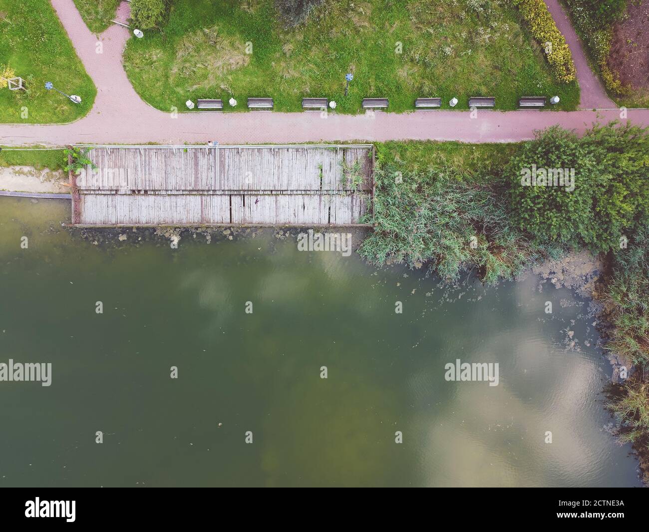 Top down view of lake and alleys in the park with reflection of clouds. Drone, aerial view Stock Photo