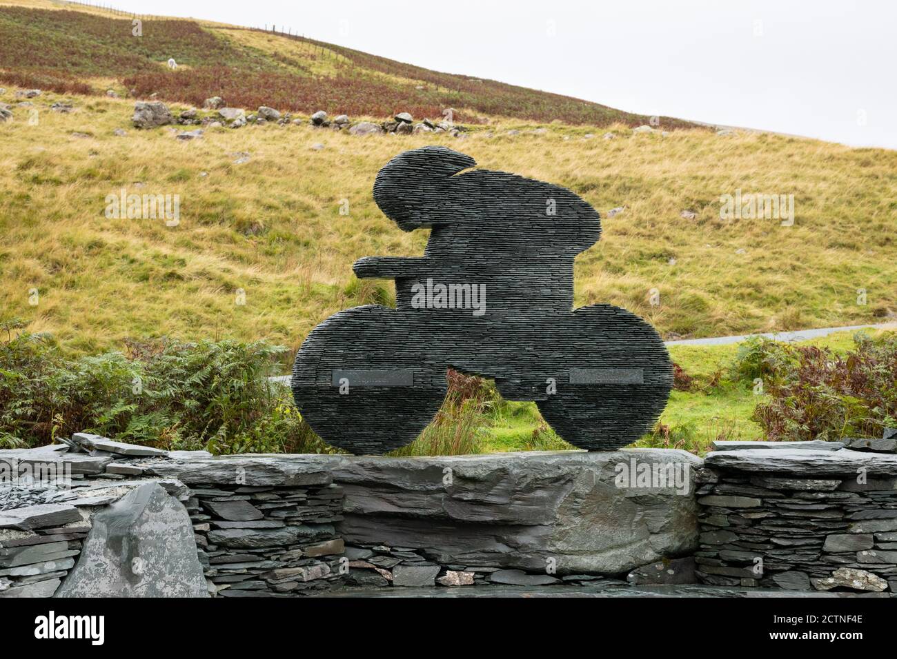 sculpture 'Endurance' of a cyclist made from slate by Terry Hawkins at Honister Slate Mine, Honister Pass, Lake District, England, UK Stock Photo