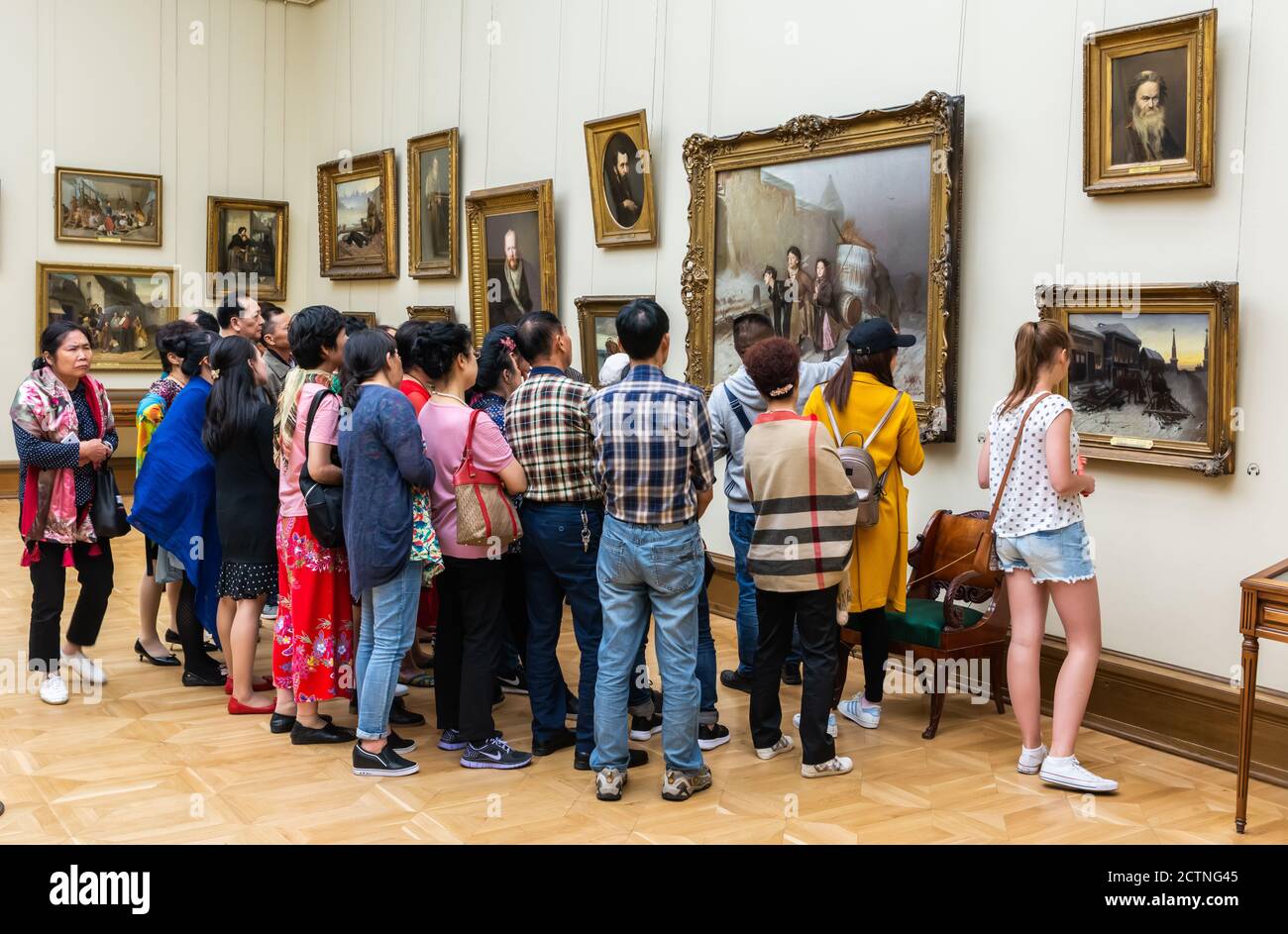 Moscow, Russia – July 1, 2017. A group of tourists in front of Troika painting by Russian painter Perov, at the Tretyakov Gallery in Moscow. Stock Photo