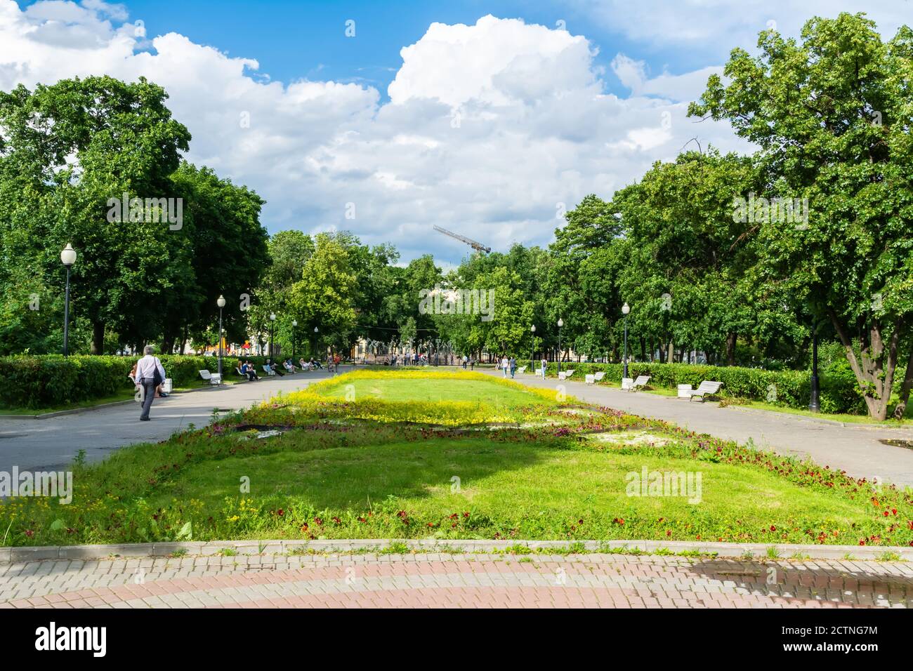 Moscow, Russia – July 1, 2017. Gardens on Bolotnaya Ploshchad square in Moscow, toward Children are Victims of Adults’ Vices sculpture by Mikhail Shem Stock Photo