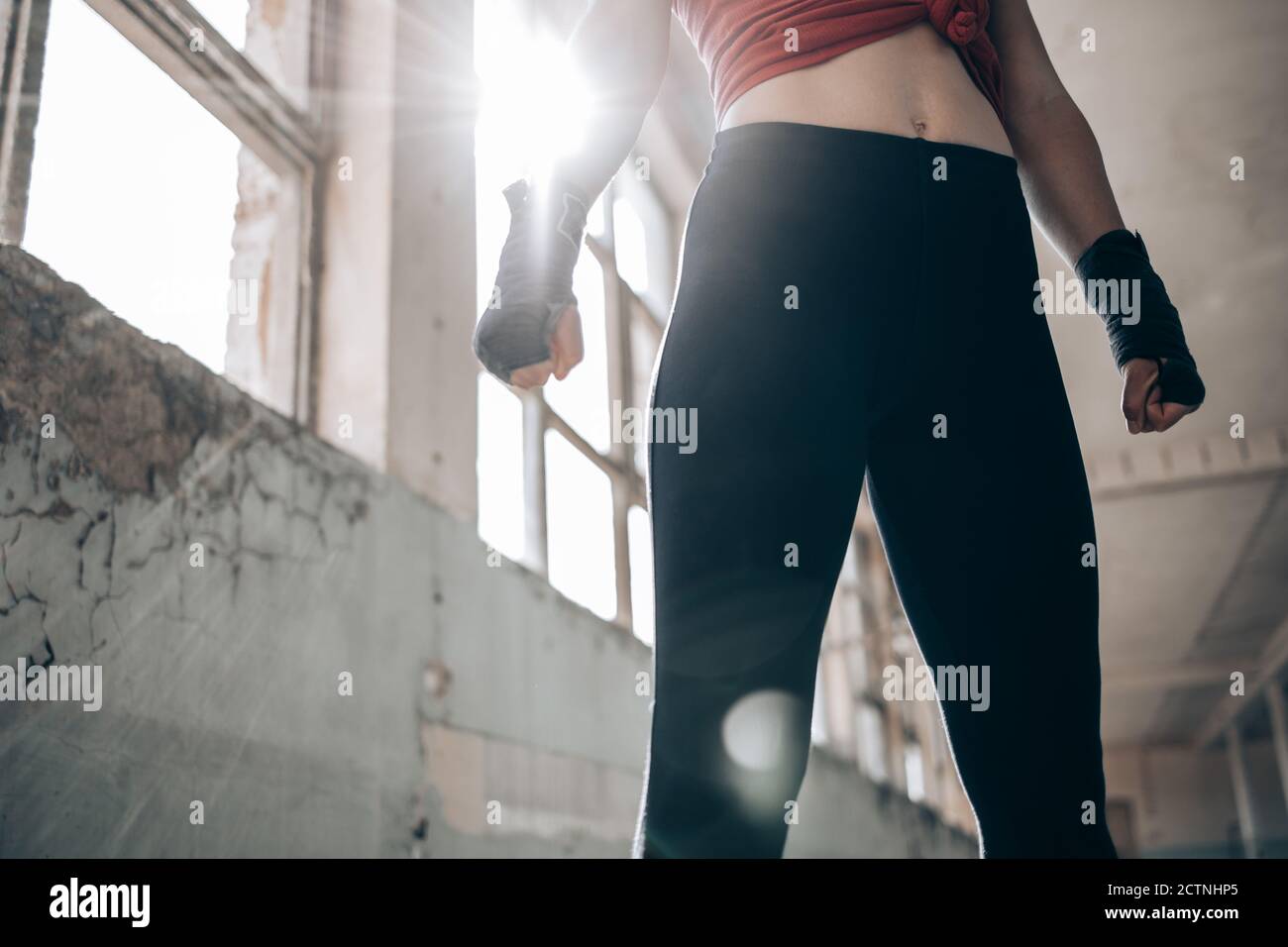 Lower part of strong, fit, female body in black leggings. Fitness fashion Stock Photo