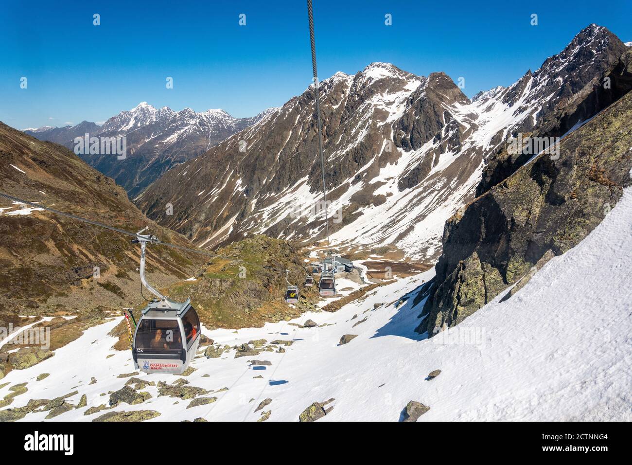 Neustift im Stubaital, Austria – May 27, 2017. Gamsgarten cable car to Stubai Glacier in Tyrol, Austria, with gondolas against the backdrop of mountai Stock Photo