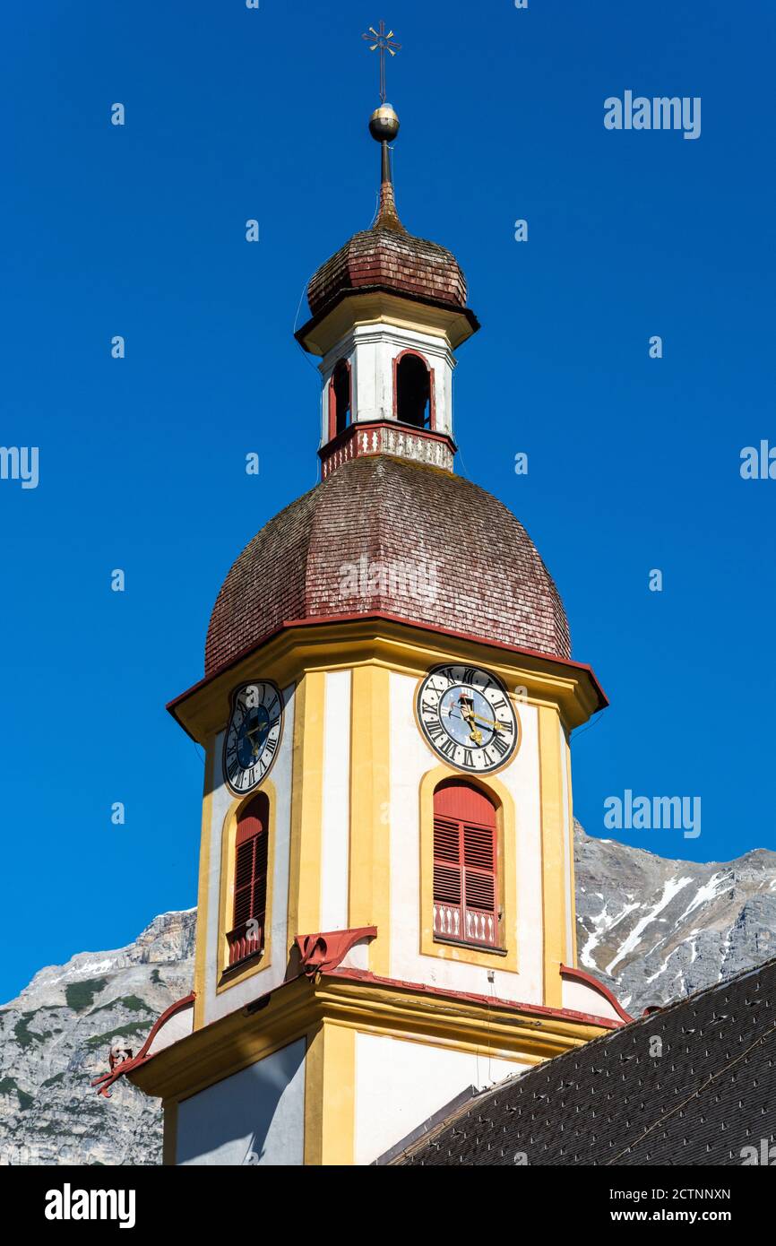 Neustift im Stubaital, Austria – May 27, 2017. Clock tower of parish church Pfarre Neustift in Neustift. Stock Photo