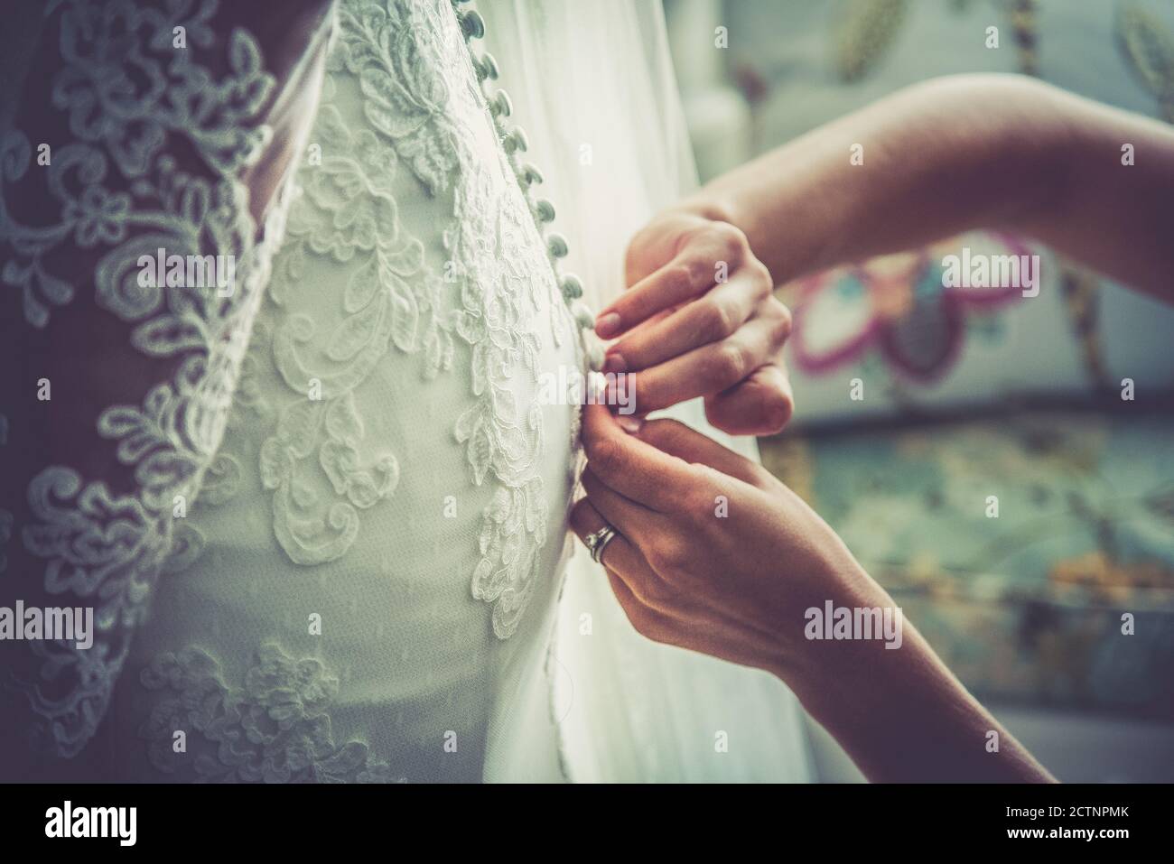 Getting into the wedding dress Stock Photo Alamy
