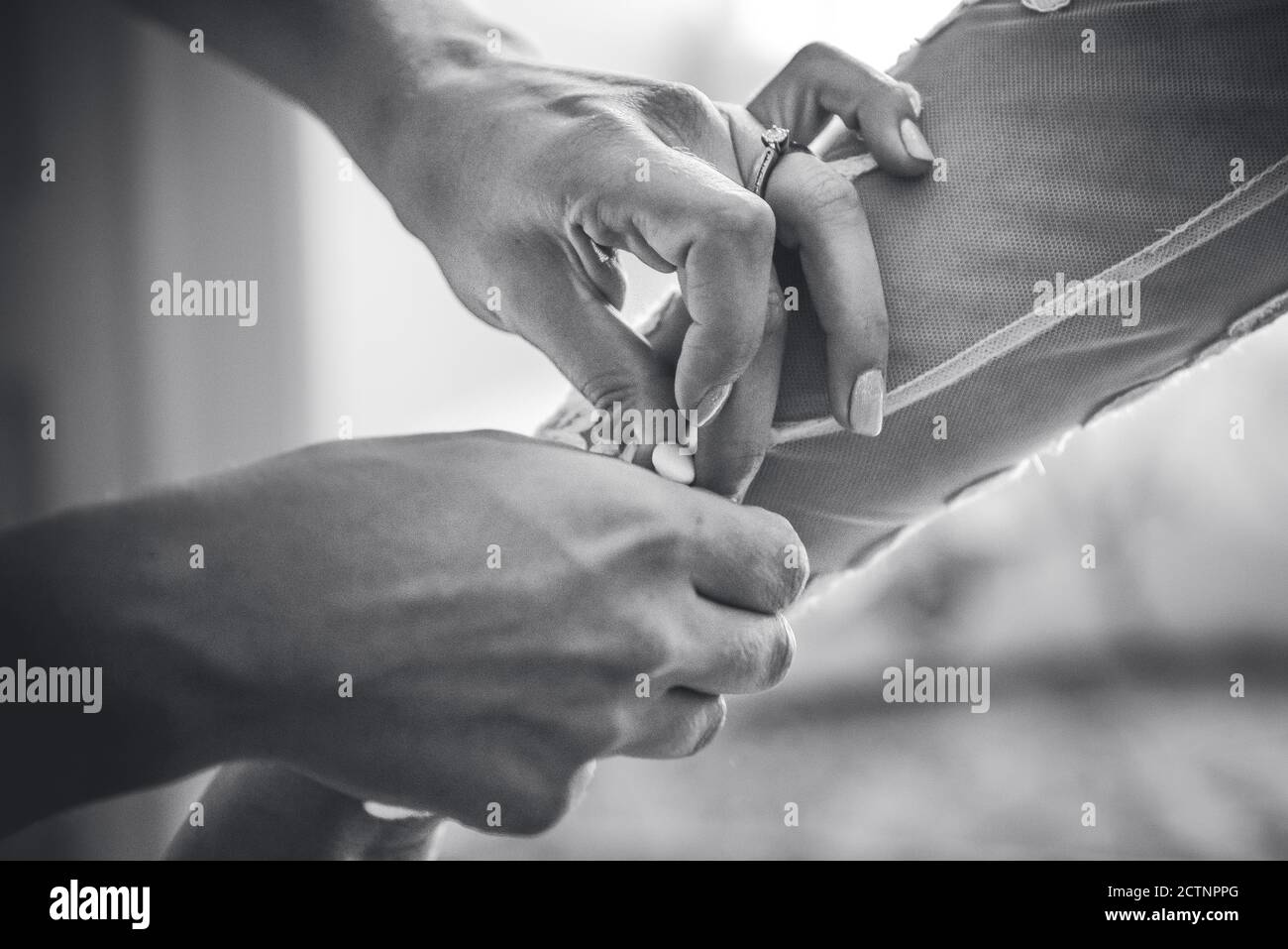 Getting into the wedding dress Stock Photo Alamy